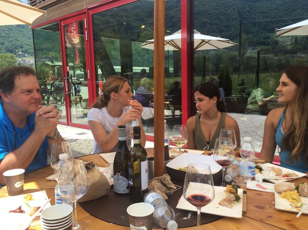 A group of people having a meal together at a restaurant in the Lake Como area