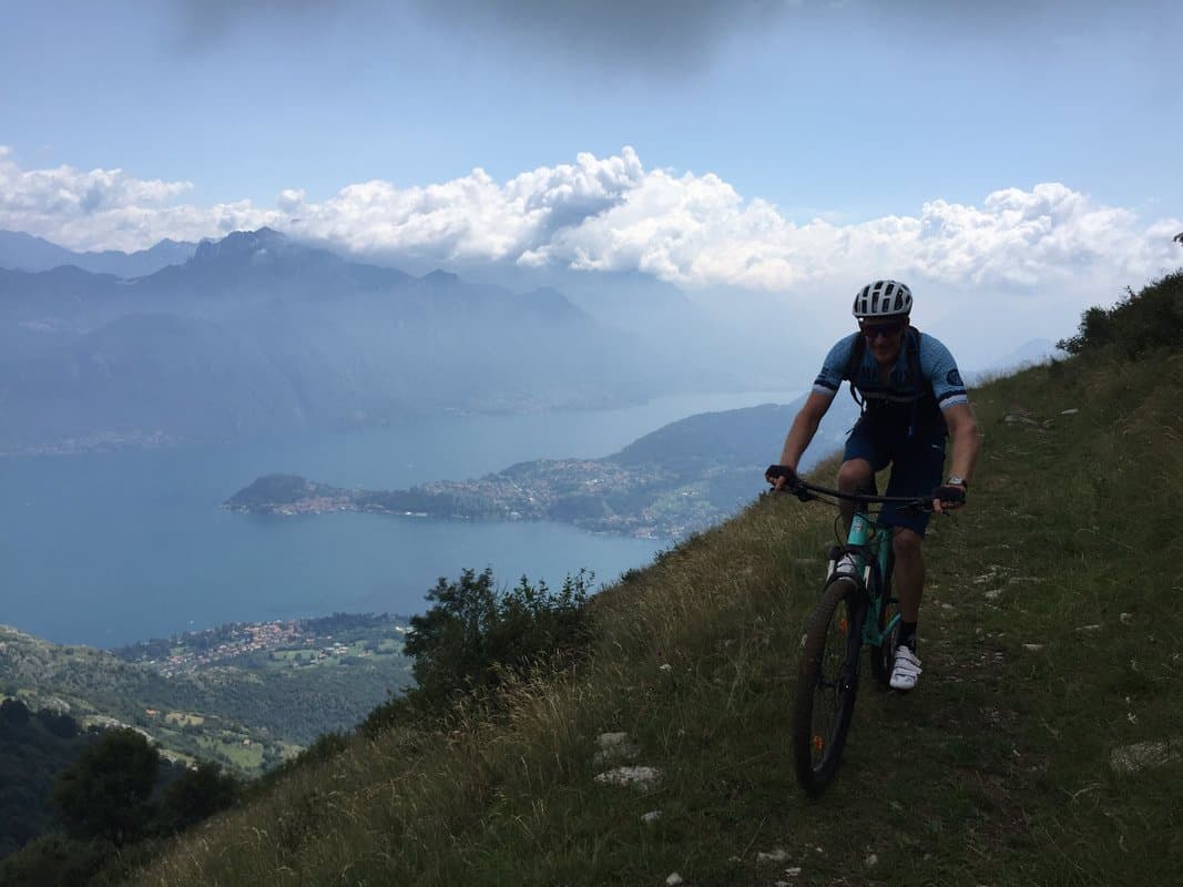Cyclist on Mountain Trail overlooking Lake Como