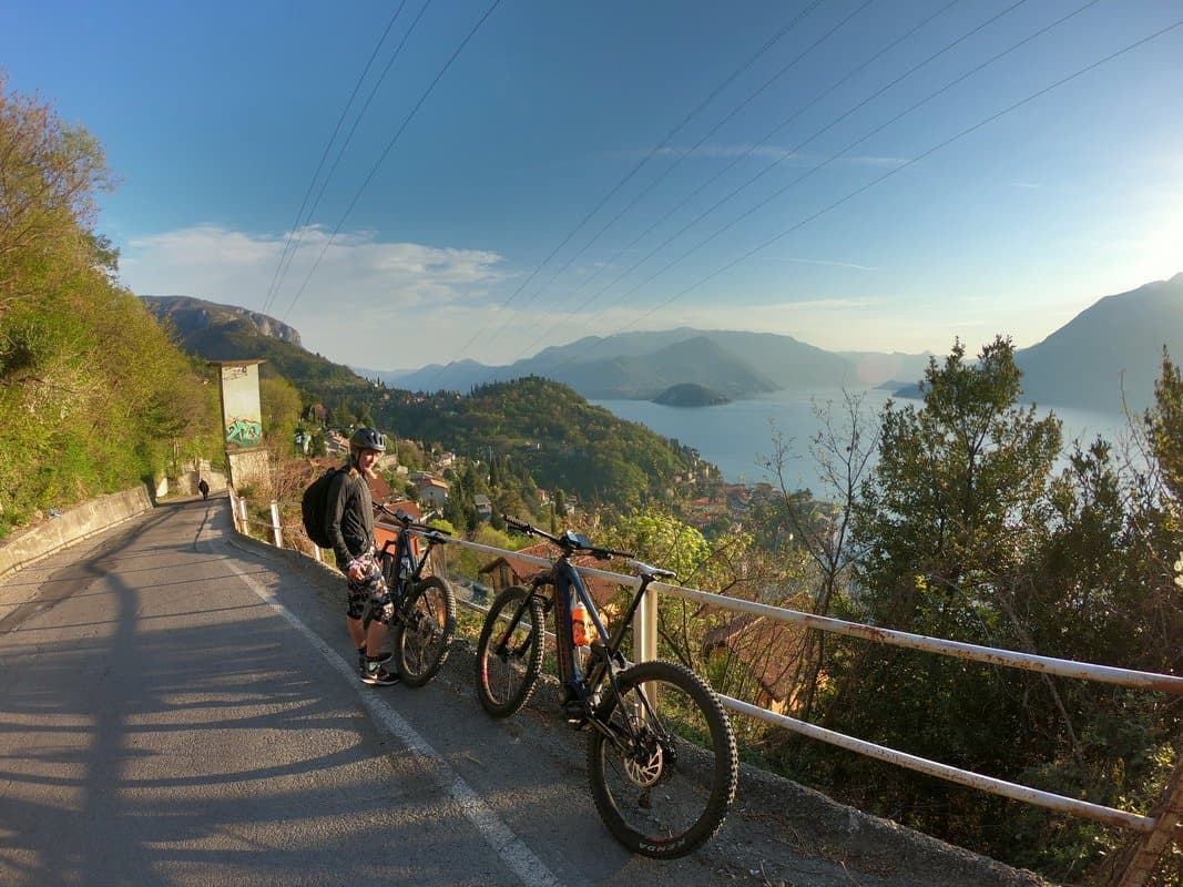 Cyclist with Bikes Overlooking Lake Como